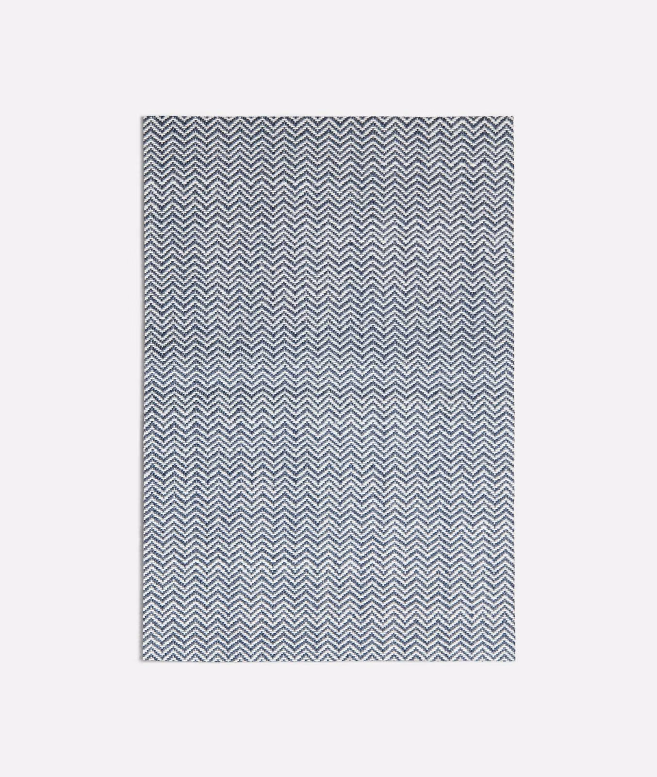 Cool blue-grey and ivory micro-chevron weave in a dense zigzag field