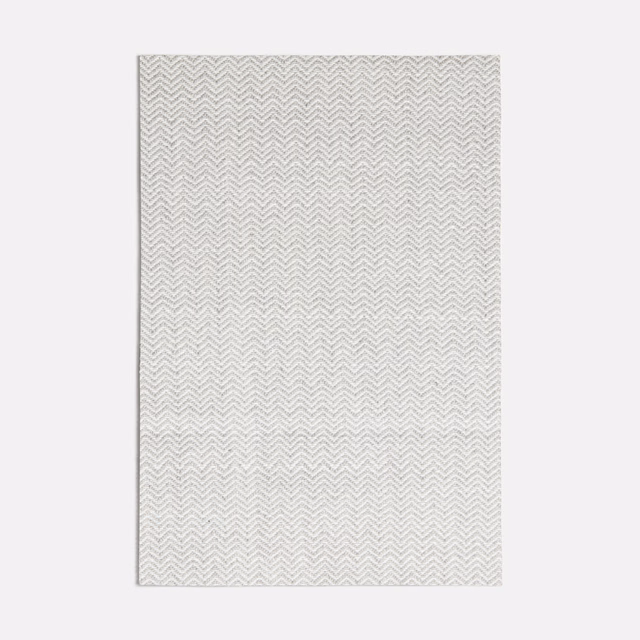 Pale cool-grey fabric swatch with a fine woven chevron herringbone texture