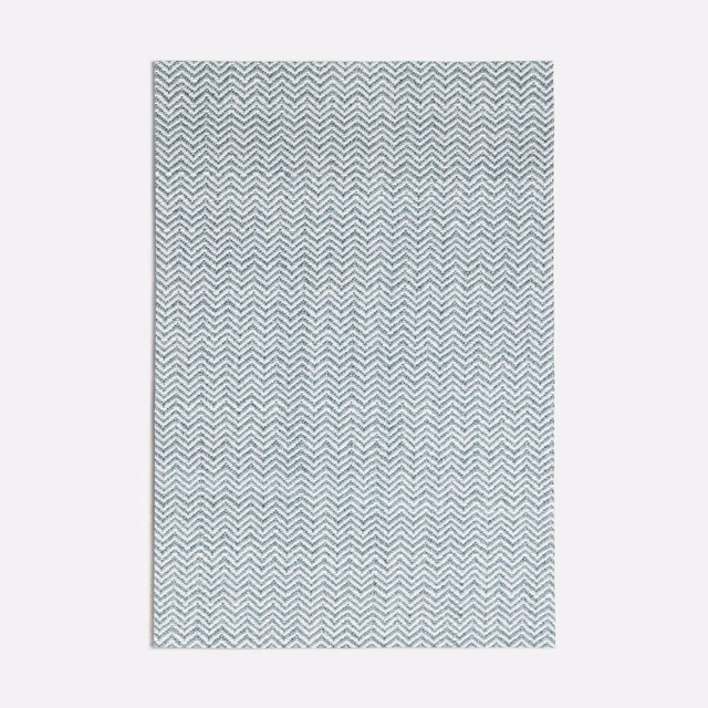 Pale seafoam fabric swatch with fine repeating white chevron weave and subtle texture