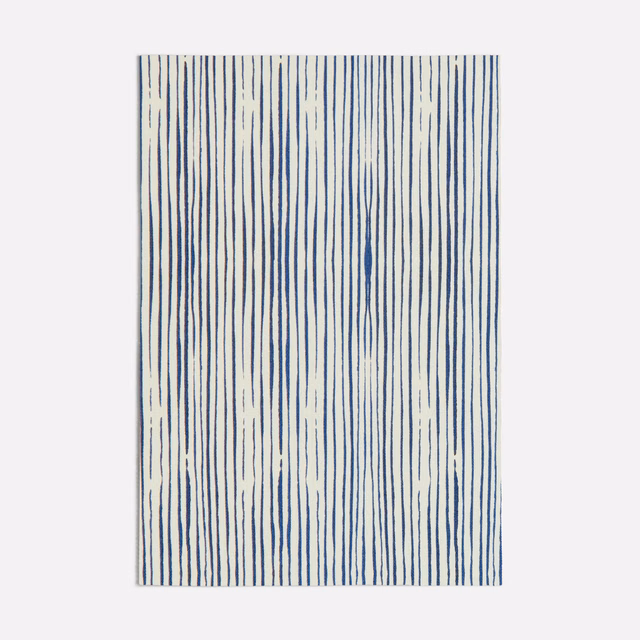 Ivory textile with irregular vertical ink-blue lines and a lightly textured surface