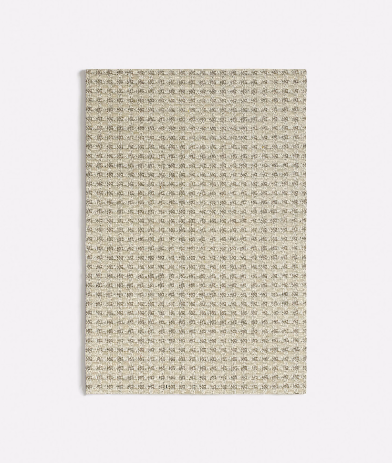 Pale greige woven fabric with tiny repeating charcoal tile marks and subtle texture