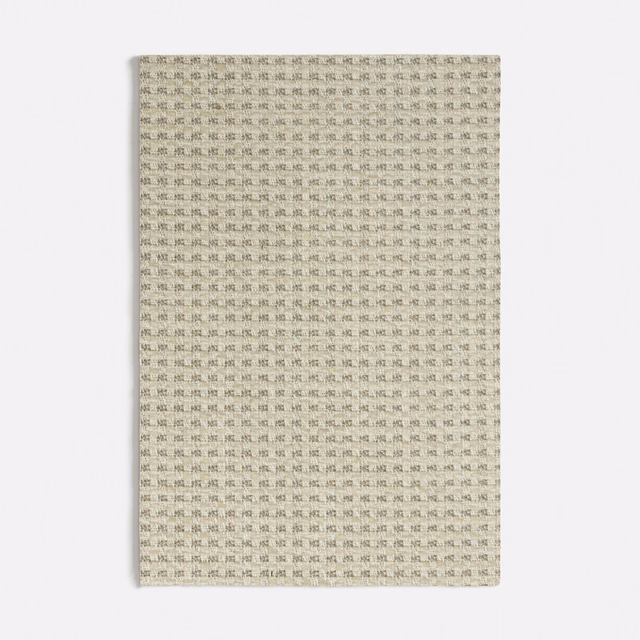 Pale greige woven fabric with tiny repeating charcoal tile marks and subtle texture