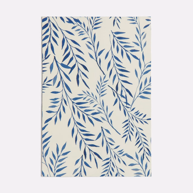 Cream textile with branching ink-blue leafy sprays in a loose vertical repeat
