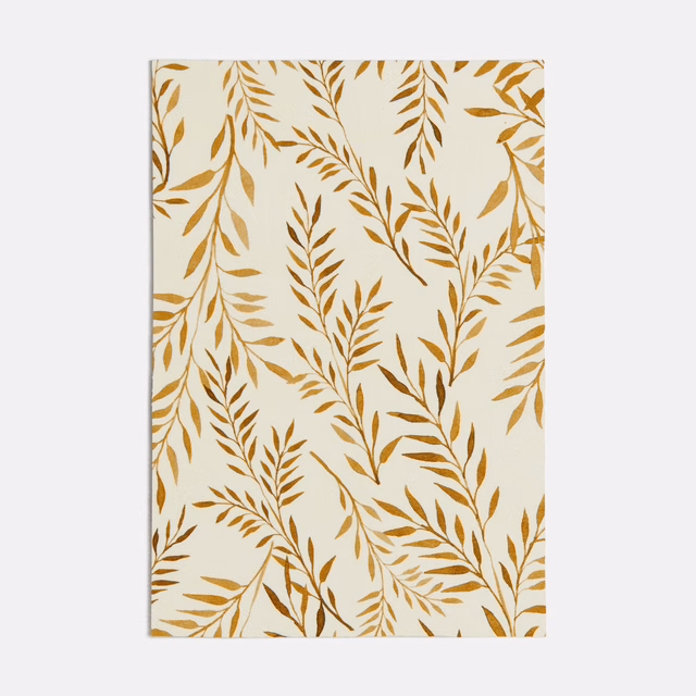 Ivory fabric with warm ochre leafy branches in an airy botanical pattern