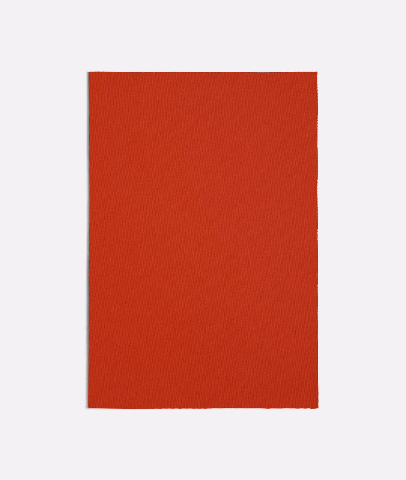 Close-up swatch of solid warm lobster-red fabric with a fine even woven texture