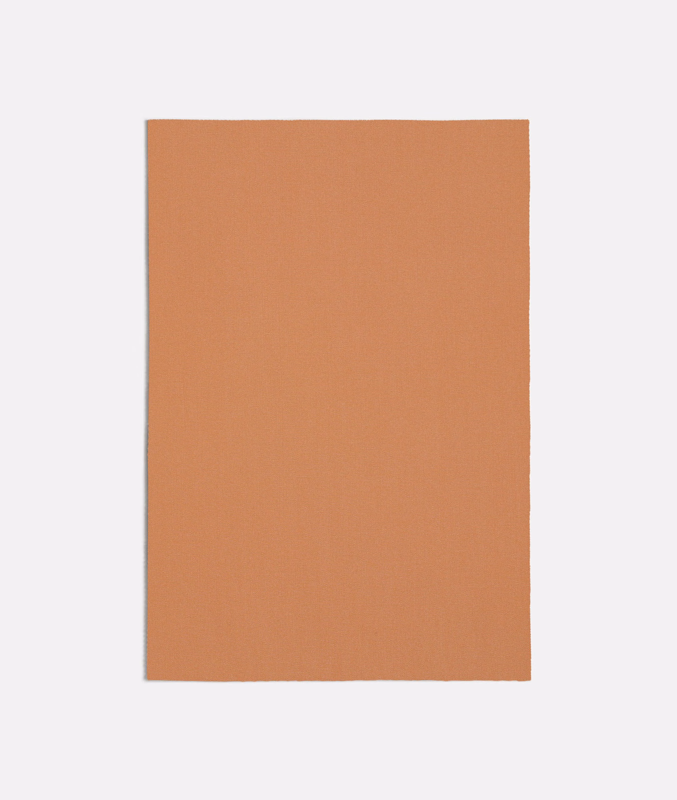 Muted peach terracotta textile with a fine, even plain weave