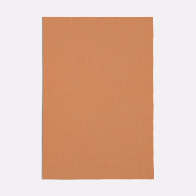 Muted peach terracotta textile with a fine, even plain weave