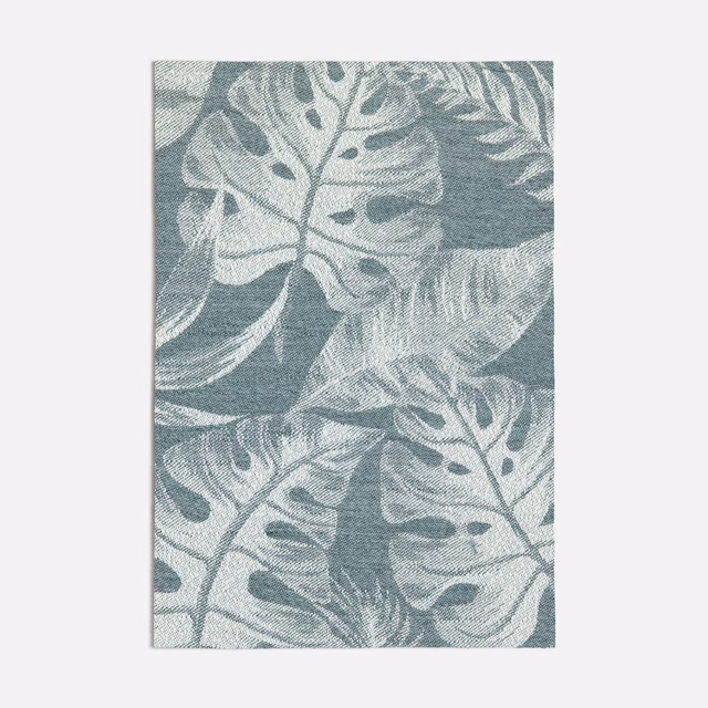 Dark seafoam woven fabric with pale oversized tropical leaves and tactile texture