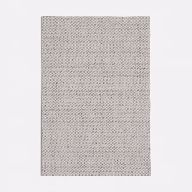 Soft warm grey textile showing a tiny interlocking weave and finely granular surface