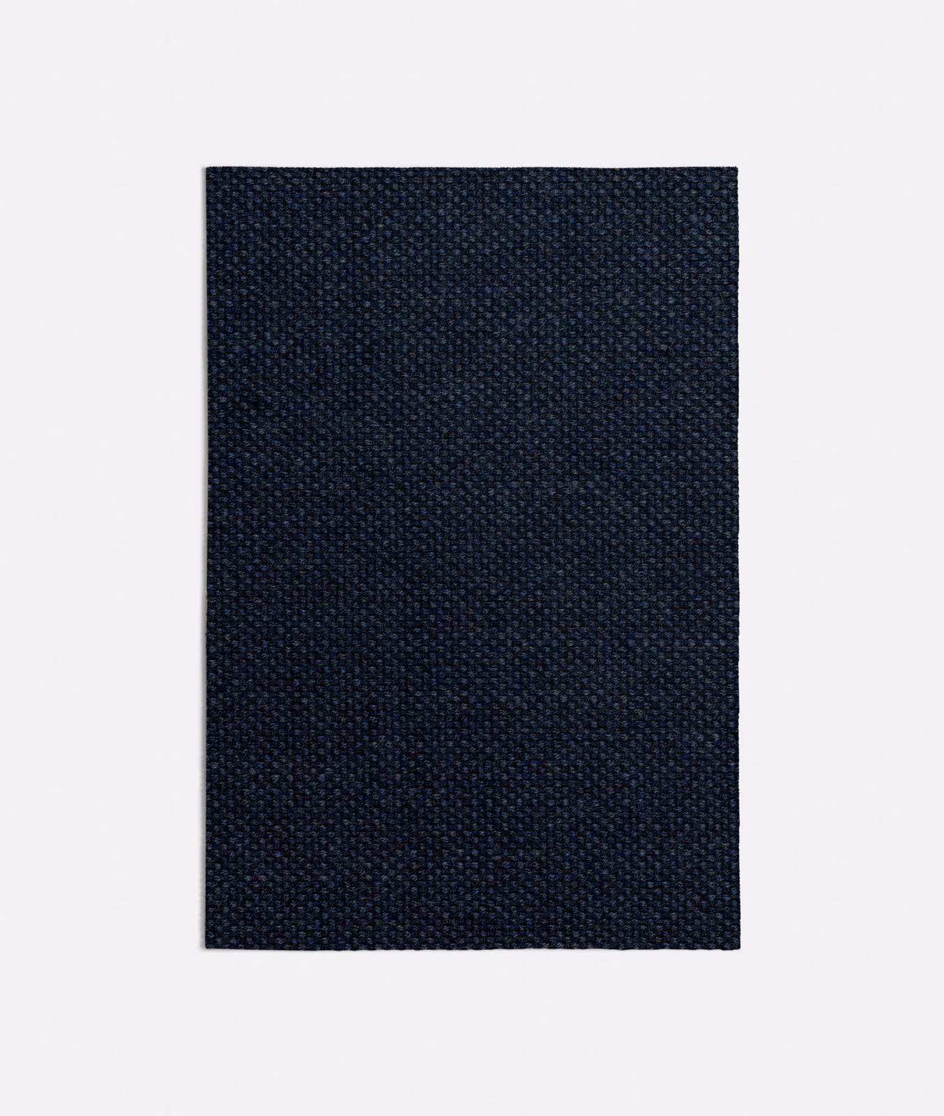 Dense tiny-weave upholstery fabric in deep navy with near-black tonal texture