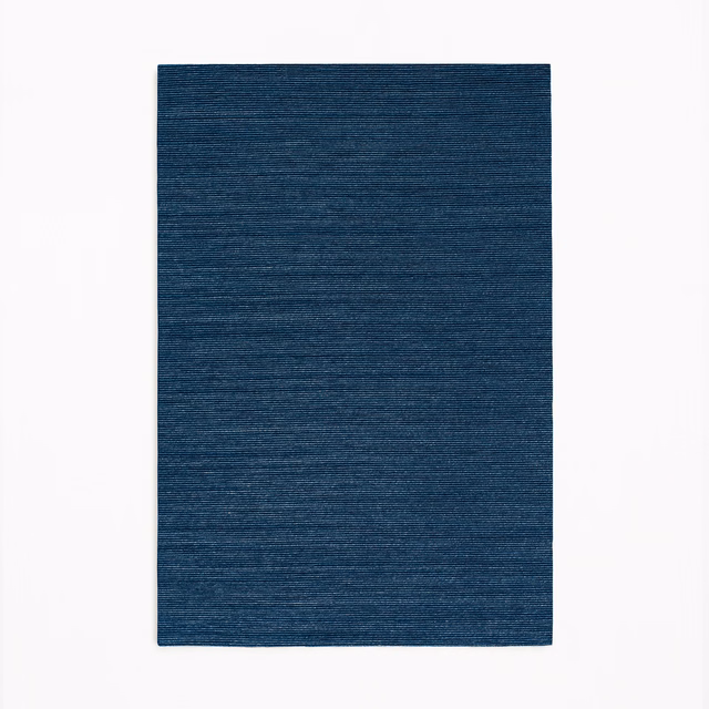 Deep navy-blue textile swatch with fine horizontal slub lines and subtle tonal variation