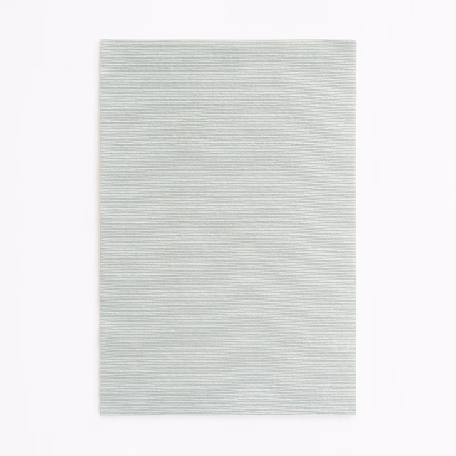 Pale ice-blue fabric swatch with fine horizontal woven texture