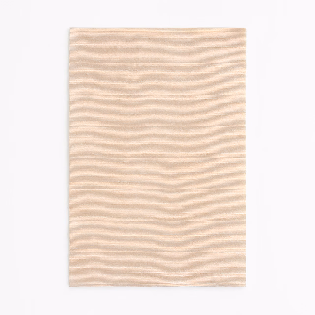Pale blush-beige fabric swatch with fine horizontal woven texture