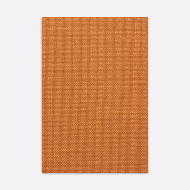 Burnt terracotta Dedar textile with a fine, even crosshatched weave