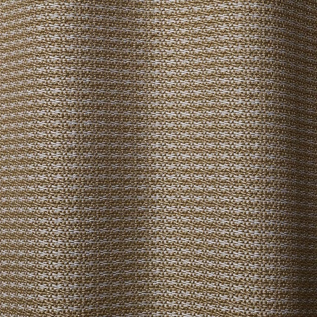 Close-up of warm gold and white horizontal woven texture with subtle slubs