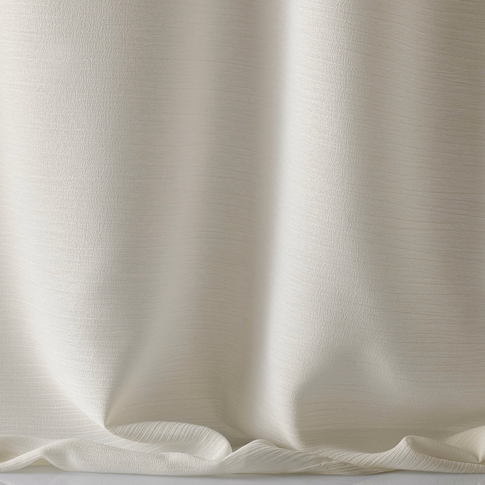 Pale ivory fabric with fine horizontal texture and softly lustrous flowing folds
