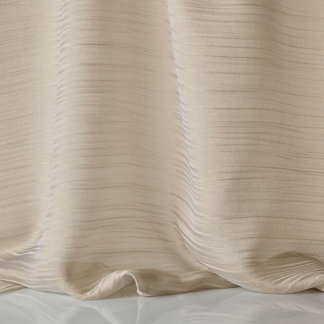 Warm champagne-beige fluid cloth with fine horizontal ripples in gathered folds