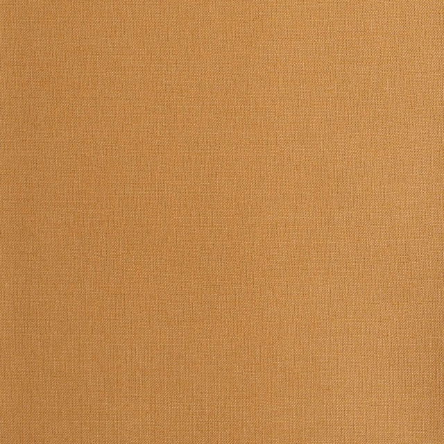 Close-up of warm amber plain weave with a fine, even textile texture