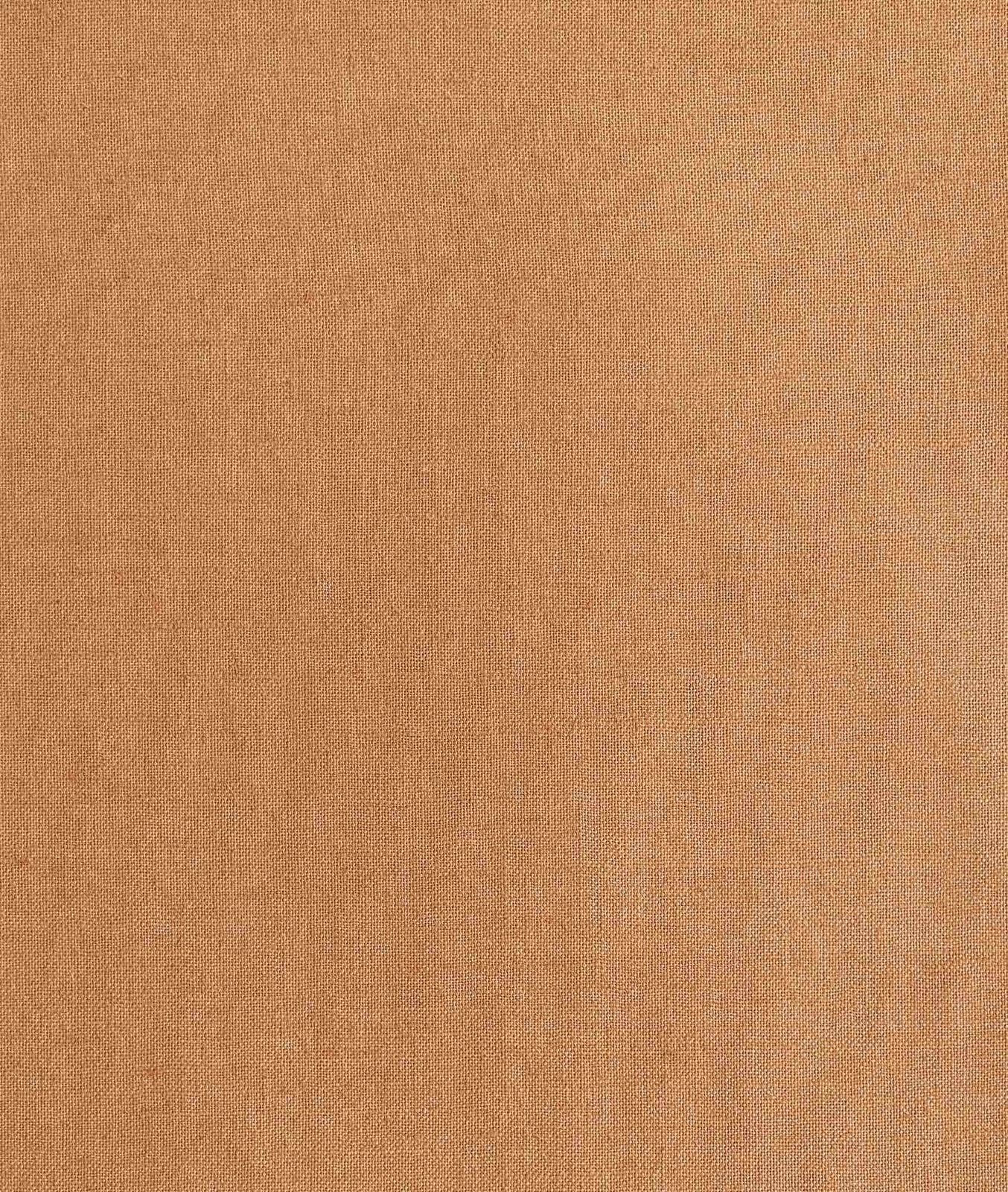 Close-up of warm terra-cotta fabric with a fine, subtly flecked woven surface