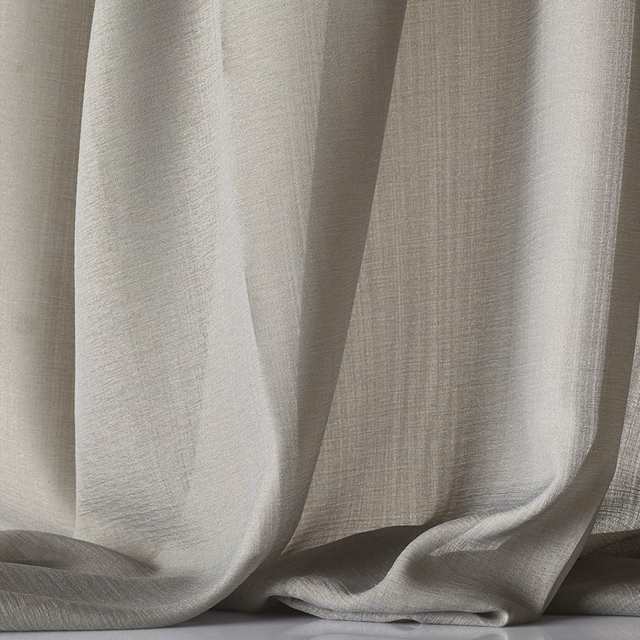 Pale greige sheer fabric in soft folds, showing a fine translucent cross-weave