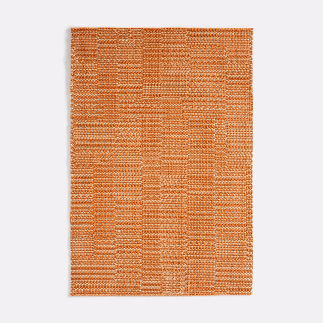Warm coral-orange woven swatch with ridged horizontal bands and subtle block pattern