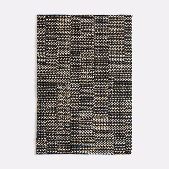Charcoal and black geometric weave with warm beige flecks in Dilmun Lava