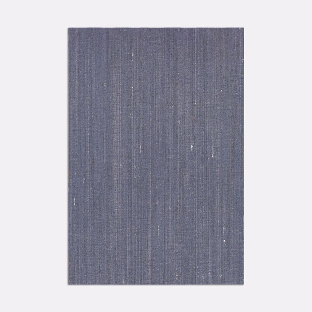 Slate blue-grey woven ground with fine vertical striations and scattered pale flecks