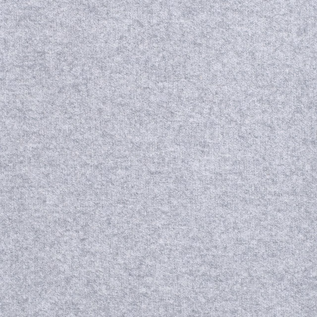 Close-up of pale cool grey fabric with a softly mottled heathered texture