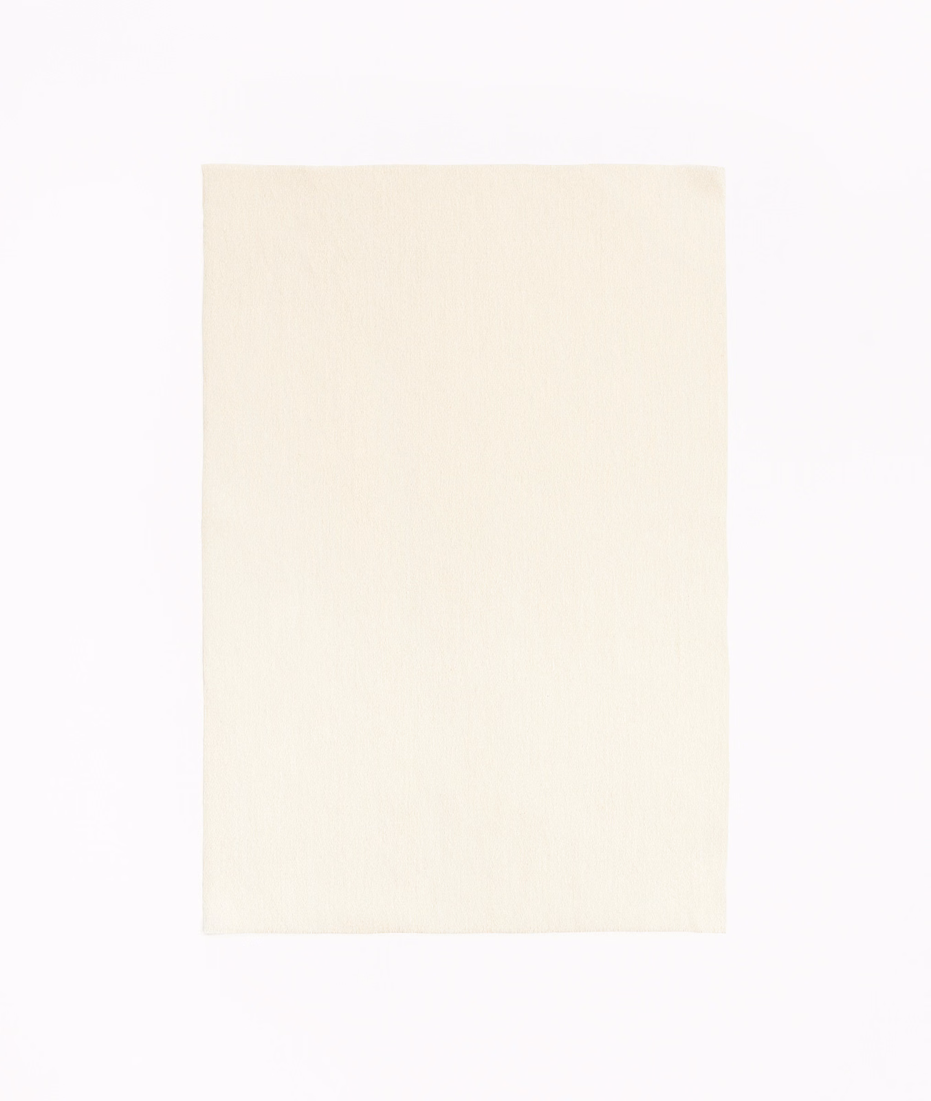 Close view of warm ivory fabric with a soft, fine vertical weave