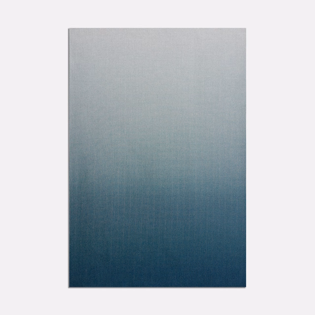 Cool grey-blue fading into deep navy across a finely woven textile swatch