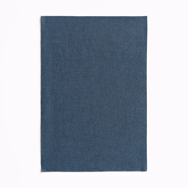 Deep denim blue fabric swatch with a fine, tightly woven micro-texture