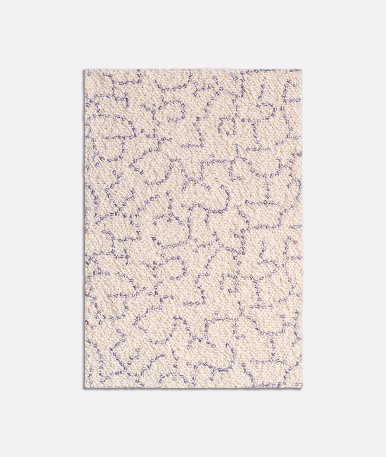 Warm ivory woven fabric with muted lilac abstract looping lines and nubby texture