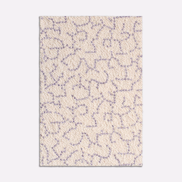 Warm ivory woven fabric with muted lilac abstract looping lines and nubby texture