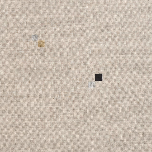 Warm greige woven textile with tiny black, ochre, blue and white geometric squares