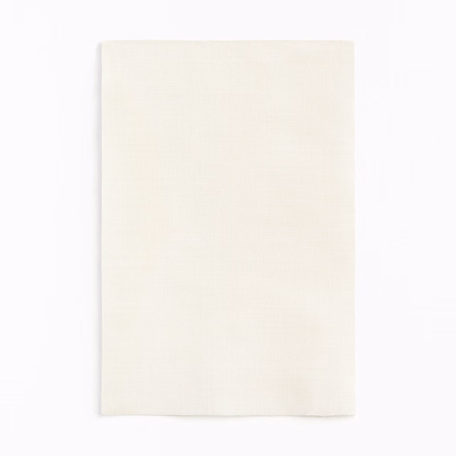 Soft ivory textile with a fine, barely visible woven grid texture