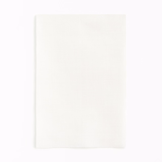 Soft ivory-white fabric swatch with a barely visible fine woven grain