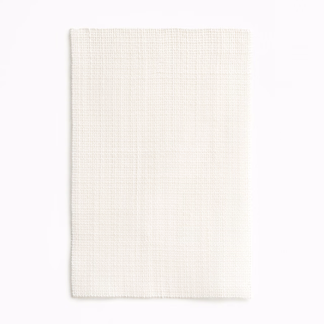 Warm ivory fabric with a fine, regular crosshatch weave and softly textured surface