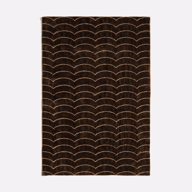 Deep brown-charcoal textile with repeating pale scalloped arcs in a dense surface weave