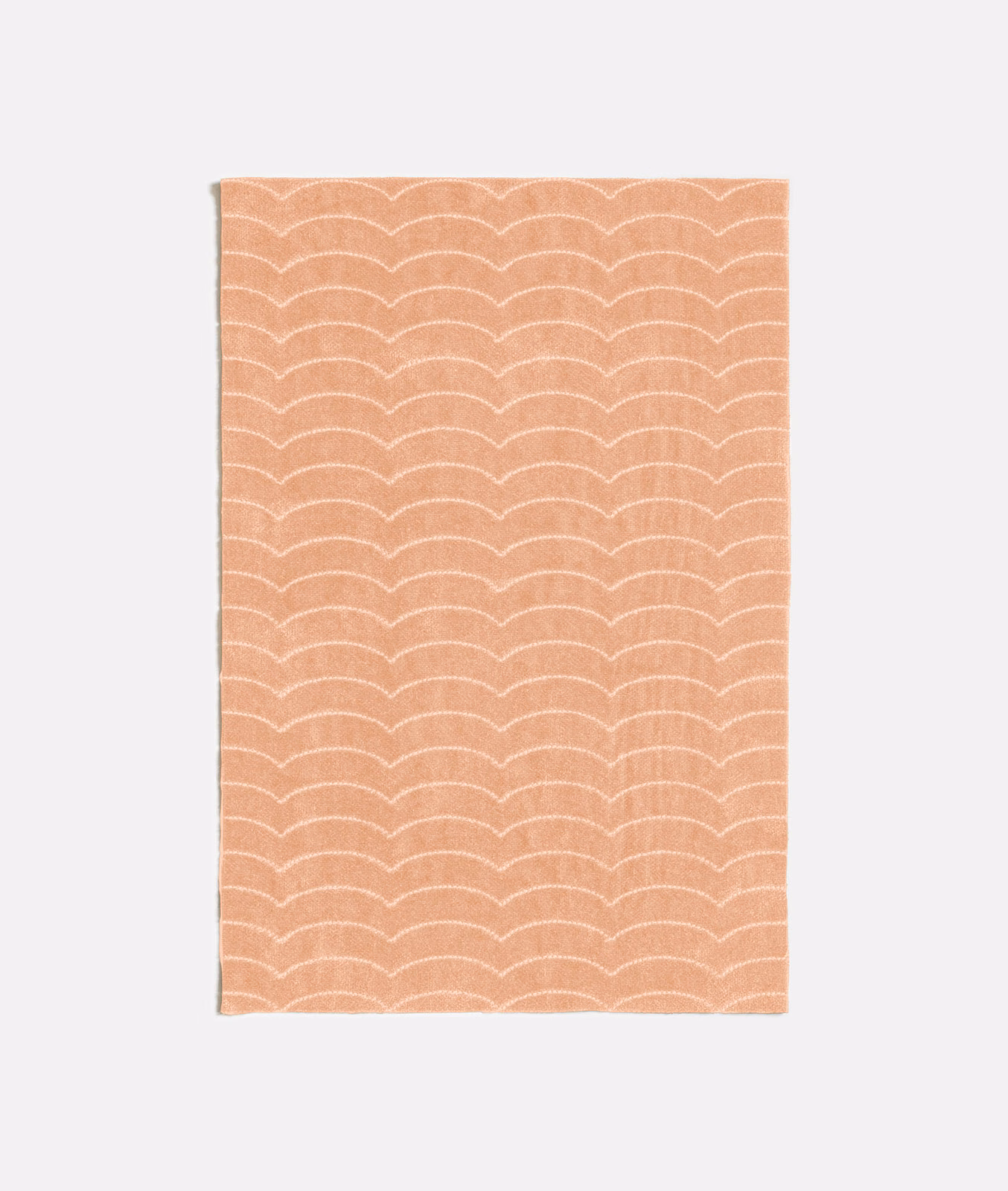 Warm peach-nude swatch with repeated pale scalloped arches and subtle woven texture