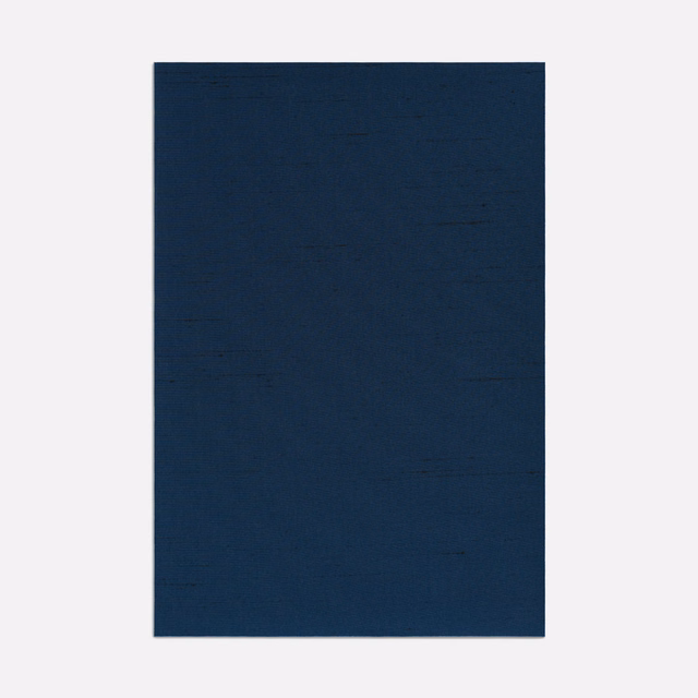 Deep navy plain weave with subtle horizontal slubs and softly uneven tonal depth