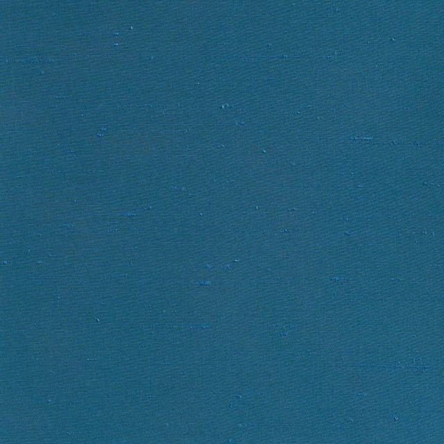 Deep Prussian teal fabric with fine ribbing and scattered subtle slub marks