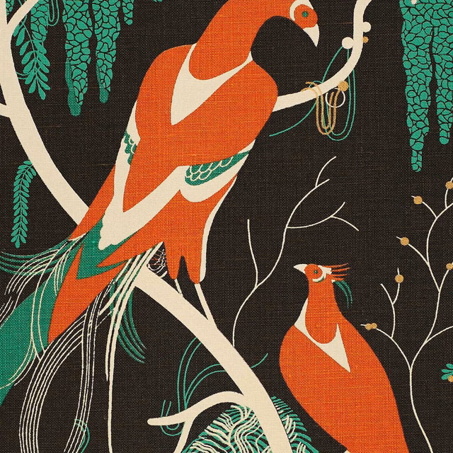 Near-black textile with coral birds, cream branches and turquoise foliage in a bold scenic pattern