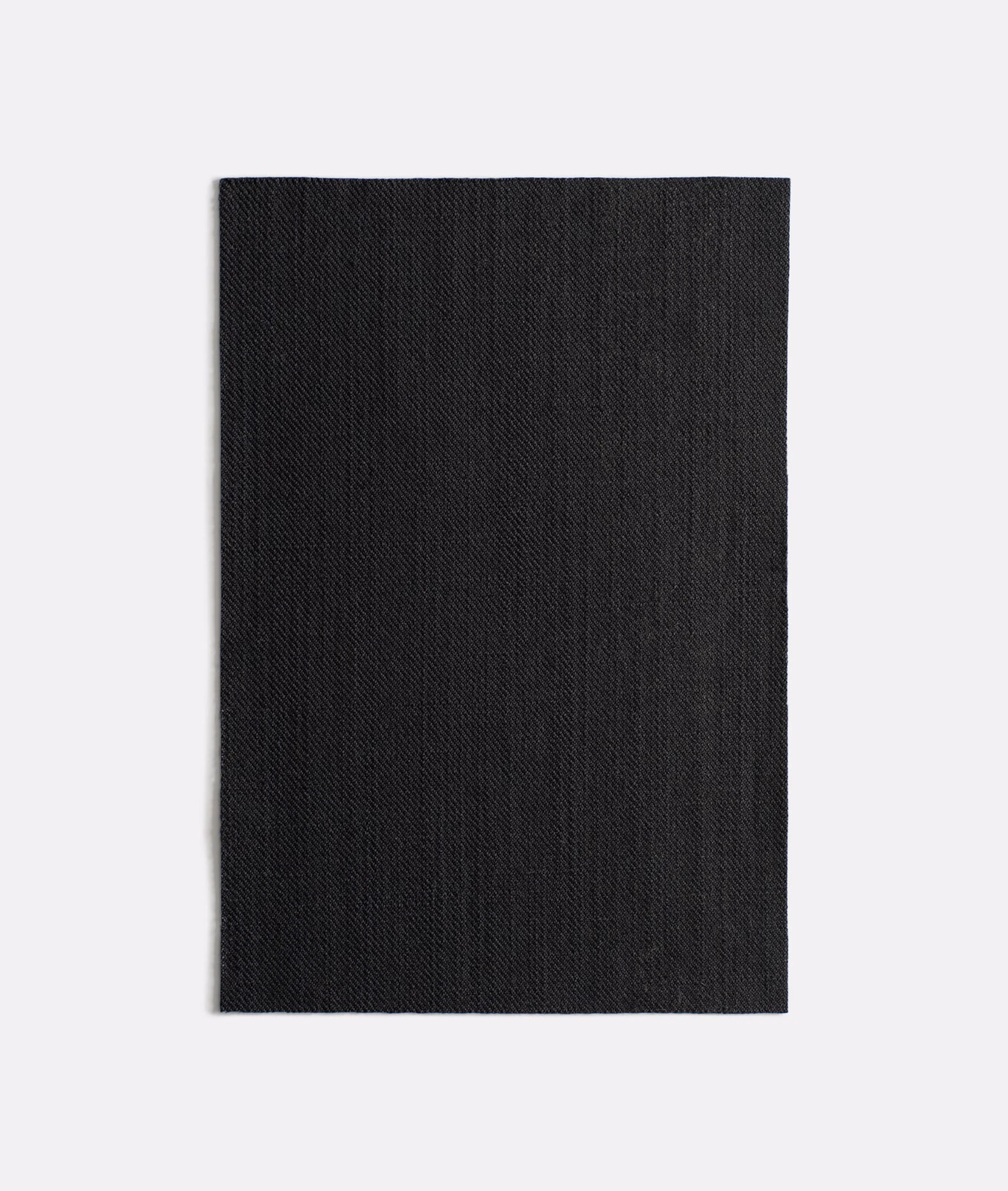 Near-black woven swatch with subtle diagonal ribbing and vertical tonal depth