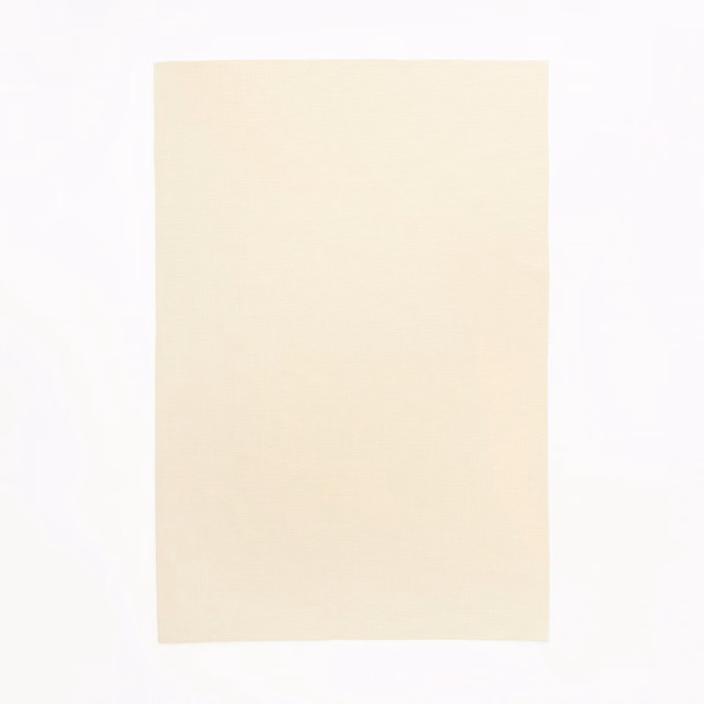Pale warm-crema textile swatch with a subtle, even woven surface