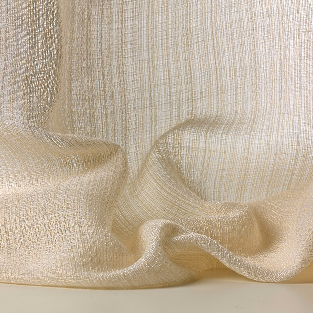 Warm ivory open-weave textile gathered into translucent, softly slubbed folds