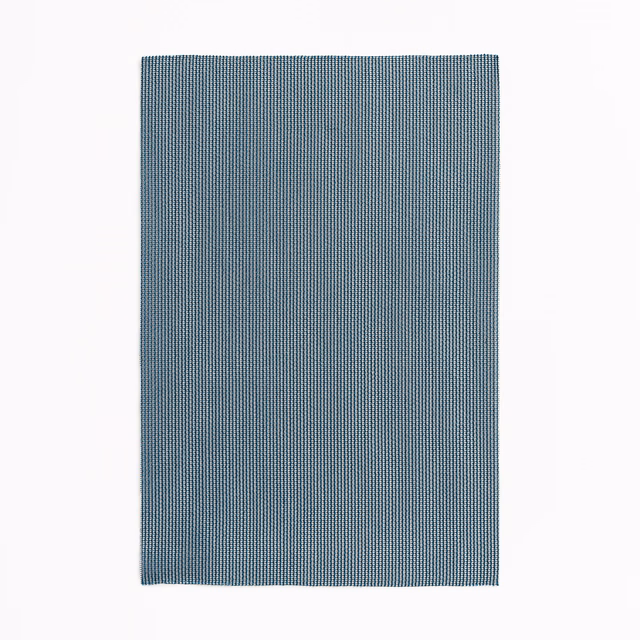 Muted petrol-blue textile with a fine, closely ribbed vertical weave