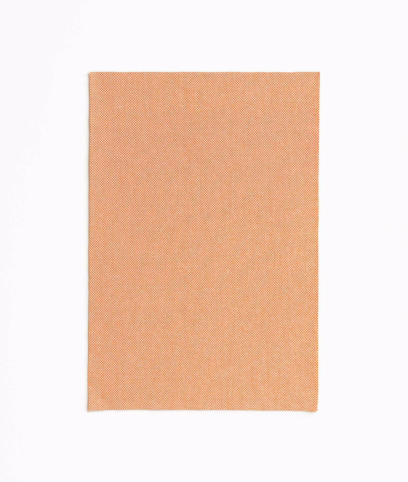Warm clementine-orange outdoor fabric with a fine, softly mottled woven texture