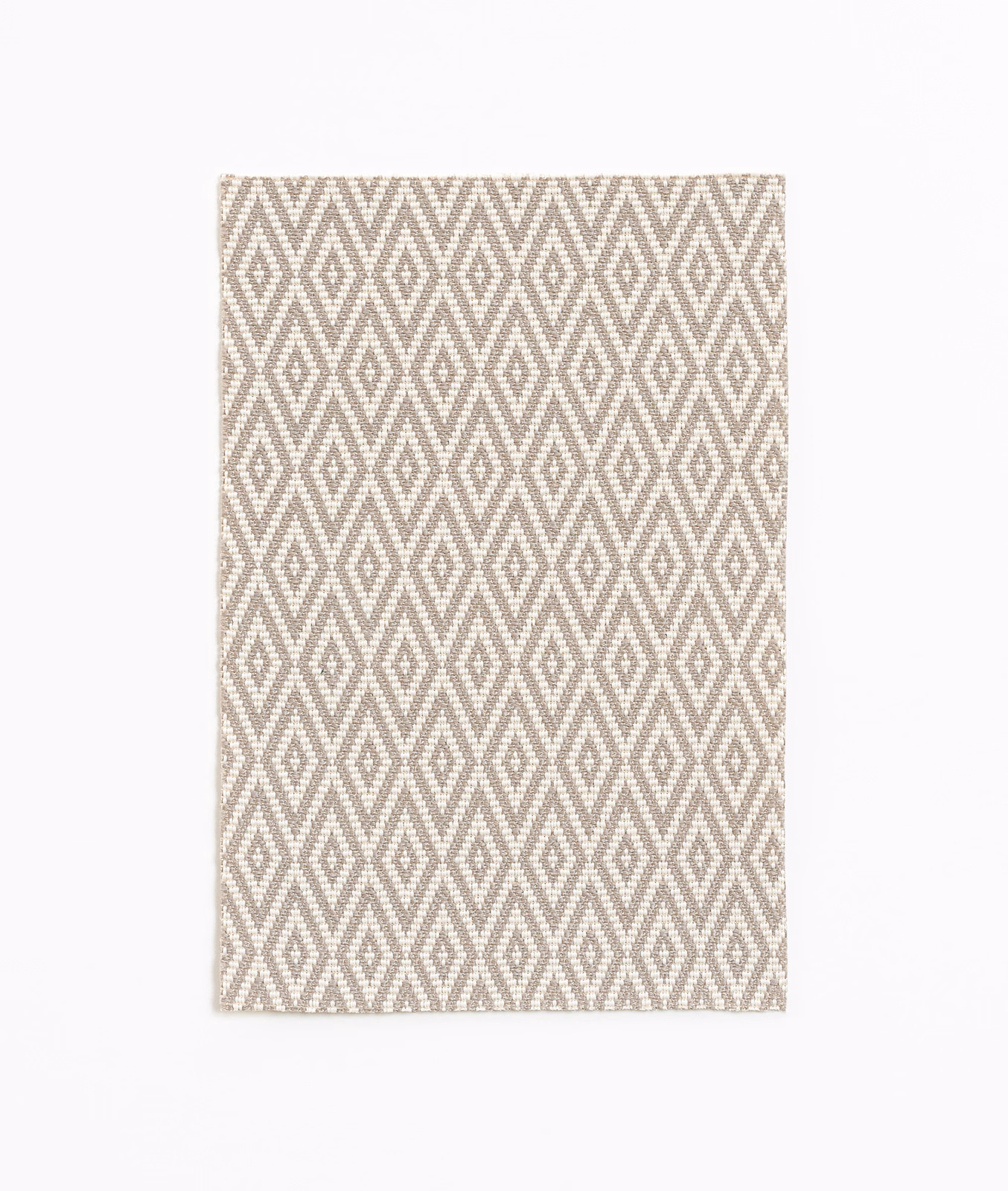 Beige and cream woven textile with repeating elongated diamond motifs