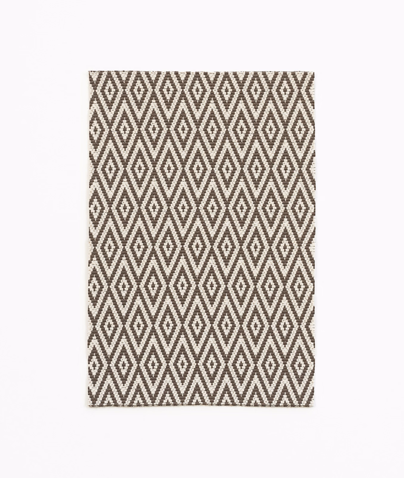 Ebony-brown and ivory woven fabric with repeating diamond and zigzag motifs