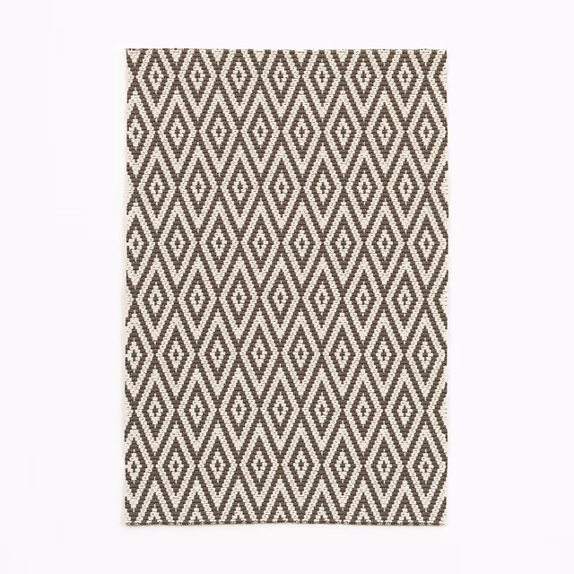 Ebony-brown and ivory woven fabric with repeating diamond and zigzag motifs
